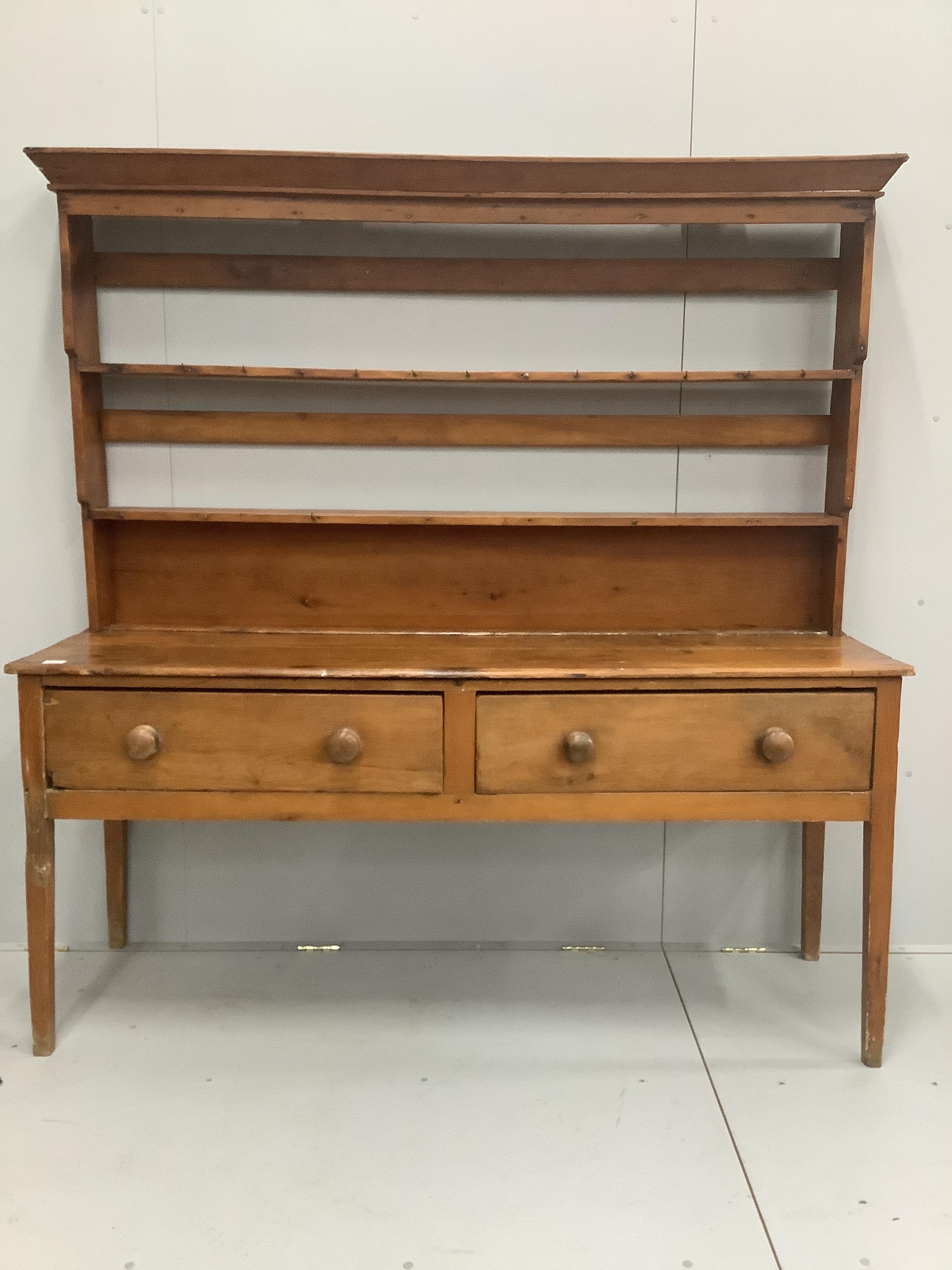 An early 19th century pine dresser with associated rack, width 184cm